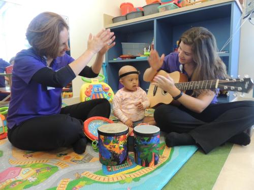 Child Life's Music Therapists singing to a patient