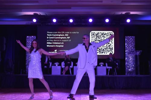 Torin Cunniningham, M.D., medical director, Orthopedic Center, Miller Children’s & Women’s Hospital and Carol Cunningham, NP, Miller Children’s & Women’s Hospital, light up the dance floor with a disco‑inspired performance honoring the Orthopedic Center  and Neonatal Intensive Care Unit at Miller Children’s & Women’s Hospital during the  Dancing for Our Stars “A Crystal Celebration.”