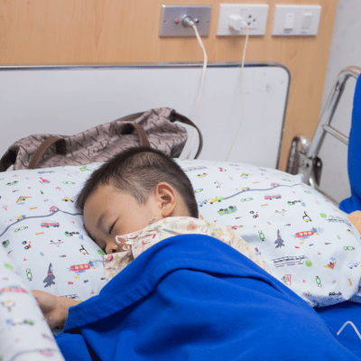 Child resting on general pediatrics care unit after experiencing sickness.