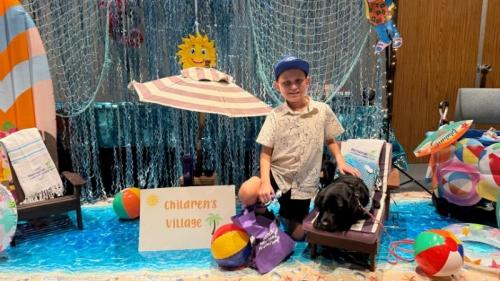 Nine-year-old Sebastian Mendoza, a patient at the Jonathan Jaques Children’s Cancer Institute, enjoys a beachside moment with Karat, Miller Children’s & Women’s facility dog, dressed as a mermaid during Beach Day—an annual event that brings the excitement of the beach to patients right inside Miller Children’s & Women’s Hospital.