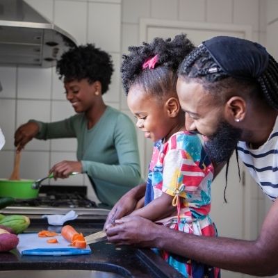 black family cooking a healthy meal together