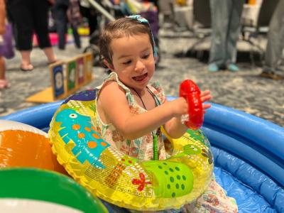 Three-year-old Sophia Garcia dives into summer fun in an inflatable pool filled with beach balls during Beach Day at Miller Children’s & Women’s Hospital, an annual summer event that brings the beach to patients right inside the hospital.
