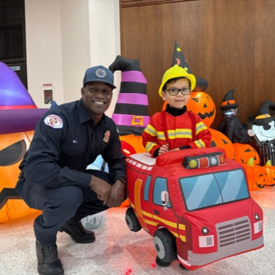 Four-year-old Luie Contrevas suits up as a firefighter and takes the wheel of his own fire engine alongside Long Beach Firefighter Calvin Bell during the Halloween celebration at Miller Children’s & Women’s Hospital.