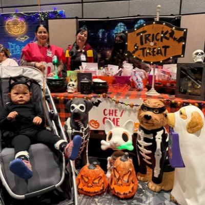Two-year-old Pepper Piñon gets into the Halloween spirit dressed as a black cat while visiting one of the elaborately decorated trick-or-treat stations at Miller Children’s & Women’s Hospital.