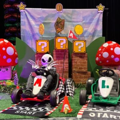 Seven-year-old Dazel Lopez, a patient at the Jonathan Jaques Children’s Cancer Institute, takes the driver’s seat dressed as Jack Skellington, showing off his long skeleton fingers on a Mario Kart-themed racetrack complete with go-karts, question blocks, mushrooms and other decorations at Miller Children’s & Women’s Hospital.