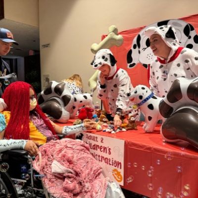 Fifteen-year-old Sally from “The Nightmare Before Christmas” visits a “101 Dalmatians”-themed trick-or-treat station filled with decorations, treats and bubbles at Miller Children’s & Women’s Hospital.