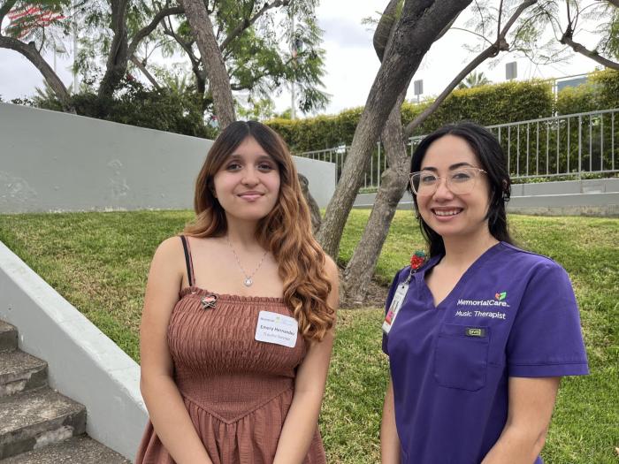 Trauma survivor Emery Hernandez shares a joyful moment with Kelly, music therapist, after performing “Imagine” by John Lennon together on stage during the Trauma Survivors Reunion—celebrating healing through music and the power of connection.
