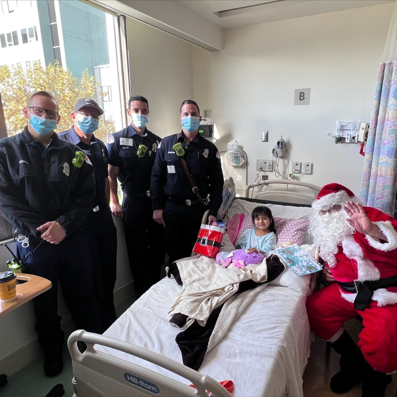 LBFD Firefighters and Santa visit a patient's bedside