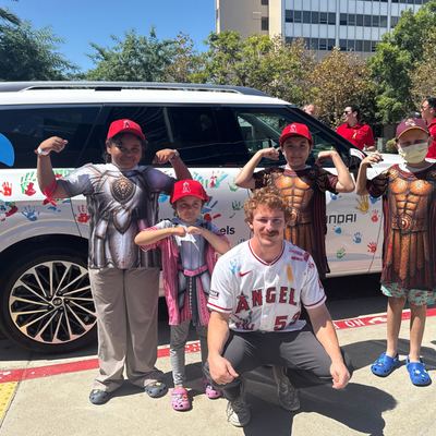 Patients of the Jonathan Jaques Children's Cancer Institute celebrate their strength and resilience alongside Los Angeles Angels outfielder Wade Meckler, who joined the event in support of children and families facing cancer, in front of a newly painted Hyundai Hope on Wheels vehicle following the Hyundai Hope on Wheels Handprint Ceremony.