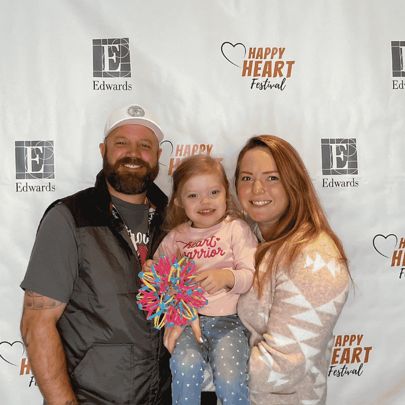 Hadley pictured with her mom and dad at Happy Heart Festival. 
