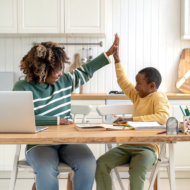 mom giving son a high-five